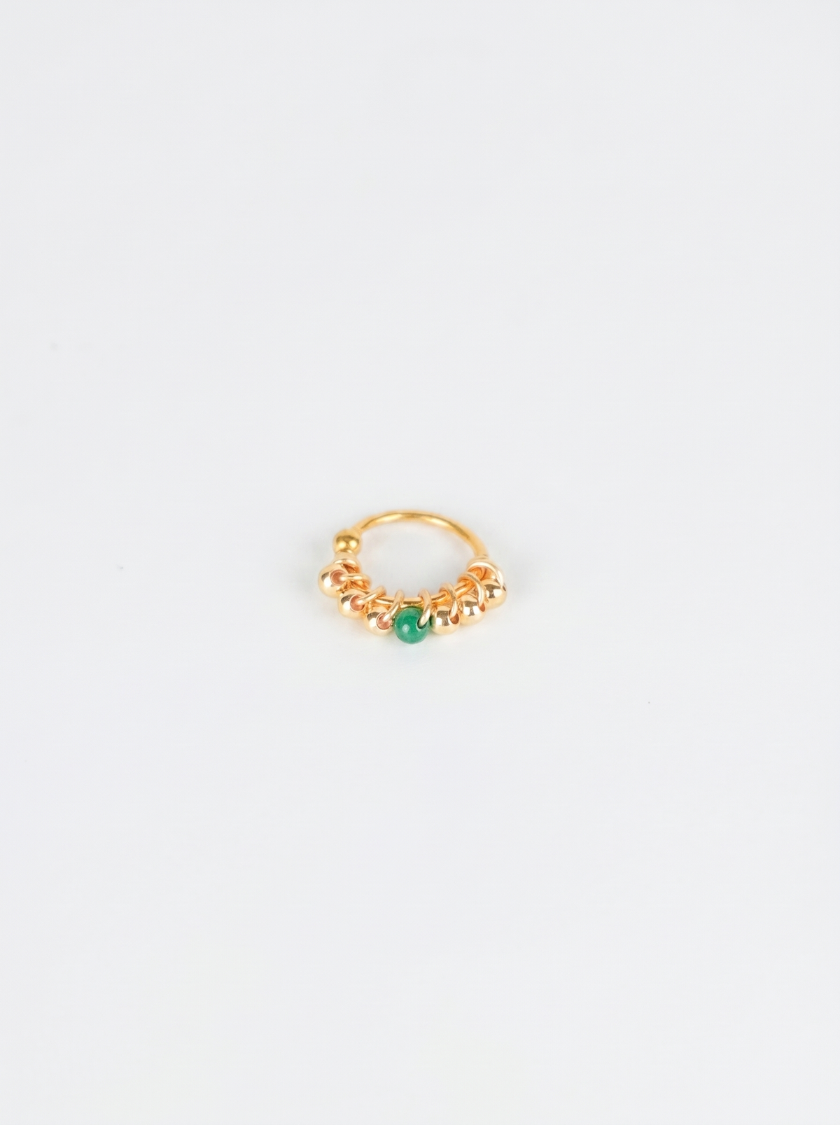 Centro | Piercing con piedra verde al centro